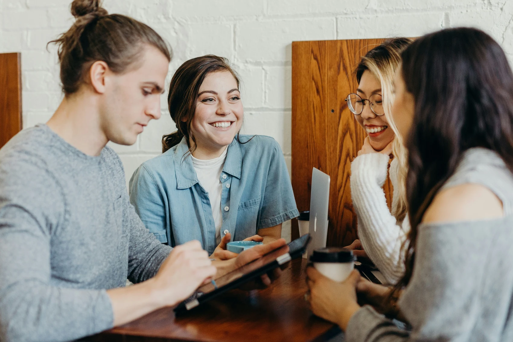 Four professionals talking together around a table